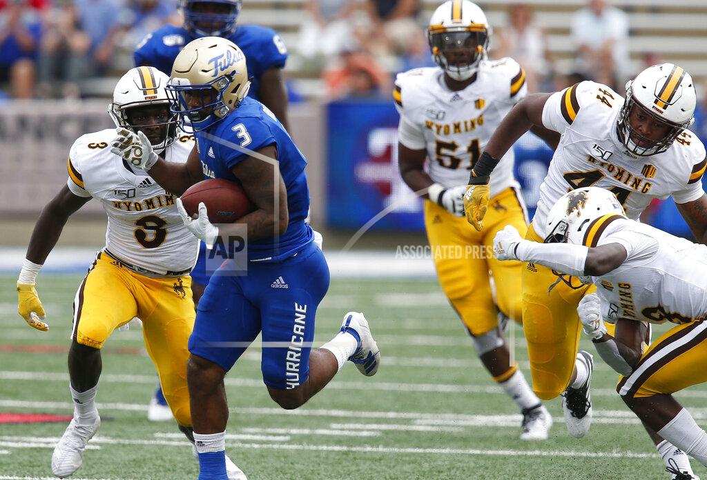 Stephen Pingry Tulsa's Shamari Brooks breaks tackles by Wyoming defenders during an NCAA college football game Saturday, Sept. 21, 2019, in Tulsa, Okla. (Stephen Pingry/Tulsa World via AP)