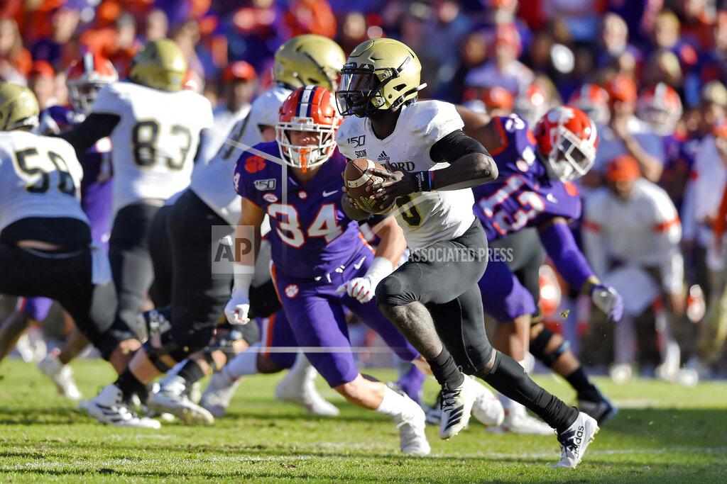 Richard Shiro Wofford quarterback Joe Newman rushes out of the backfield during the first half of an NCAA college football game against Clemson, Saturday, Nov. 2, 2019, in Clemson, S.C. (AP Photo/Richard Shiro)