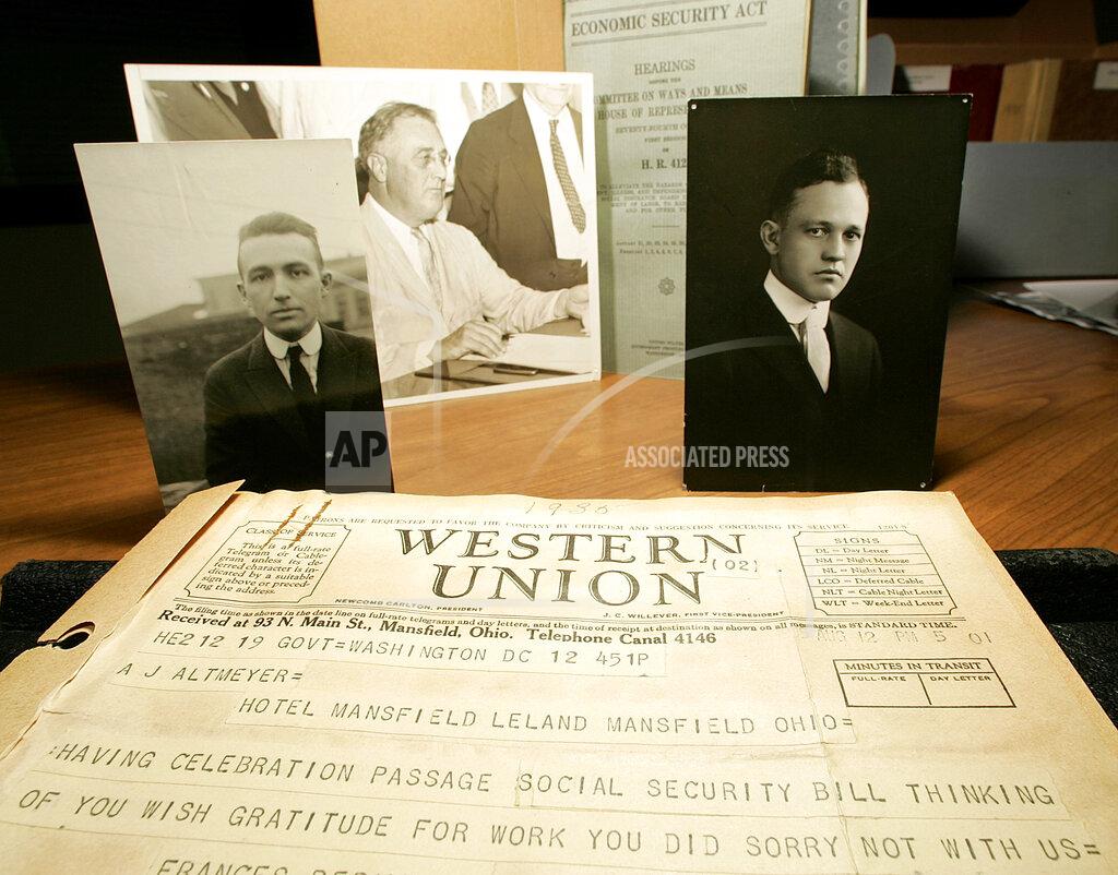 Andy Manis FILE - This Aug. 11, 2005, photo taken at the Wisconsin Historical Society in Madison, Wis., shows a telegram dated, Aug. 12, 1935, from then Labor Secretary Frances Perkins congratulating Arthur Altmeyer with helping craft the Social Security Act that passed and was signed by President Franklin D. Roosevelt into law on Aug. 14, 1935, top center photo. Edwin Witte, pictured right, and Altmeyer, both University of Wisconsin economists, were instrumental in drafting and shepherding the Social Security Act under FDRs administration. (AP Photo/Andy Manis, File)
