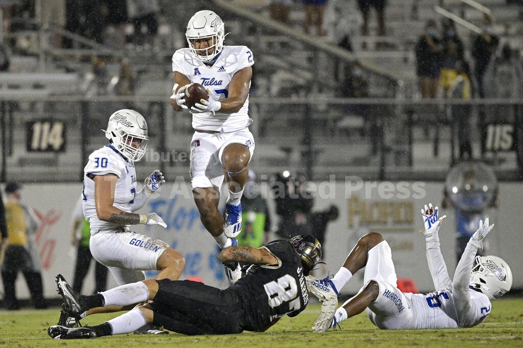 Tulsa linebacker Zaven Collins (23) intercepts a pass intended for Central Florida wide receiver Jacob Harris (87) after the ball was deflected by Tulsa linebacker Justin Wright (30) and cornerback Akayleb Evans (26) during the first half of an NCAA college football game Saturday, Oct. 3, 2020, in Orlando, Fla. (AP Photo/Phelan M. Ebenhack)