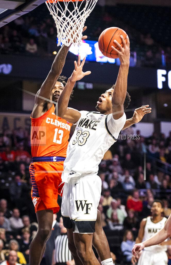 Andrew Dye Wake Forest forward Ody Oguama (33) shoots next to Clemson guard Tevin Mack (13) during an NCAA college basketball game Saturday, Feb. 1, 2020, in Winston-Salem, N.C. (Andrew Dye/The Winston-Salem Journal via AP)