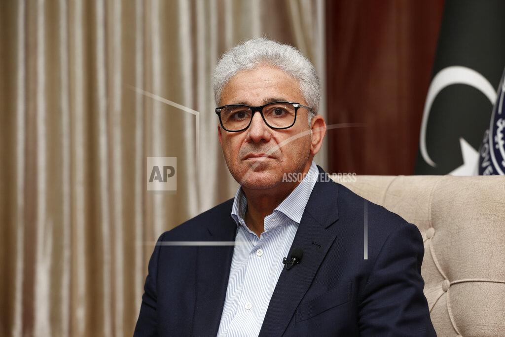 Yousef Murad Fathi Bashagha, one of Libya’s rival prime ministers, gives an interview to The Associated Press, in Sirte, Libya, Wednesday, May 25, 2022. In the interview Bashagha said that he has no immediate plans to return to the capital Tripoli and attempt to rule the country from there, after an attempt last week sparked clashes. His government will work from its headquarters in the city of Sirte — on Libya’s Mediterranean coast half-way between the country’s east and west. Rival administrations from each end of Libya claim to be its legitimate rulers until elections are held. (AP Photo/Yousef Murad)