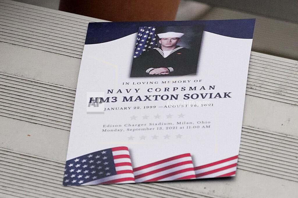 Tony Dejak The itinerary of events rests on a bench during the funeral of Navy Corpsman Maxton Soviak at Edison High School Stadium, Monday, Sept. 13, 2021, in Milan, Ohio. Soviak was one of 13 U.S. troops killed in a suicide bombing at Afghanistan's Kabul airport on Aug. 26. (AP Photo/Tony Dejak)