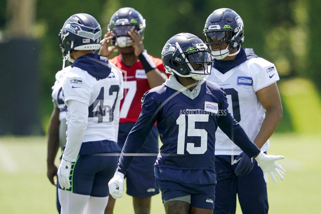 Ted S. Warren Seattle Seahawks wide receiver Marquise Goodwin (15) reaches out to greet teammates during NFL football practice Monday, May 23, 2022, in Renton, Wash. (AP Photo/Ted S. Warren)