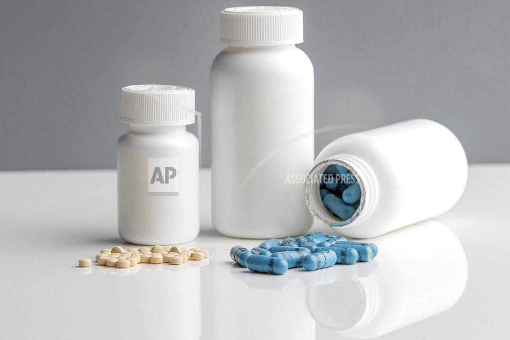 Georgia Kirkos This November 2020 photo provided by McMaster University shows 75mg aspirin pills, left, and Polycaps, pills from India-based Cadila Pharmaceuticals that contains one cholesterol and three blood pressure medicines, used in the International Polycap Study 3 (TIPS-3). On Friday, Nov. 13, 2020, researchers say the cheap, daily pill taken with low-dose aspirin can cut the risk of heart attacks, strokes and heart-related deaths by nearly one third. (Georgia Kirkos/McMaster University via AP)