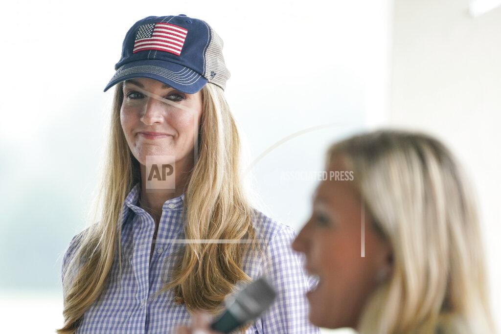 Brynn Anderson Sen. Kelly Loeffler, R-Ga., listens to Republican congressional candidate Marjorie Taylor Greene speak during a news conference on Thursday, Oct. 15, 2020, in Dallas, Ga. (AP Photo/Brynn Anderson)