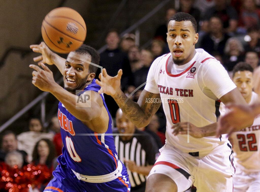 Odessa American After recovering a rebound, Texas Tech's Kyler Edwards (0) has the ball knocked out of his hands from behind by Houston Baptist's Ian Dubose (0) during the first half of an NCAA college basketball game Wednesday, Nov. 13, 2019, in Midland, Texas. (Ben Powell/Odessa American via AP)