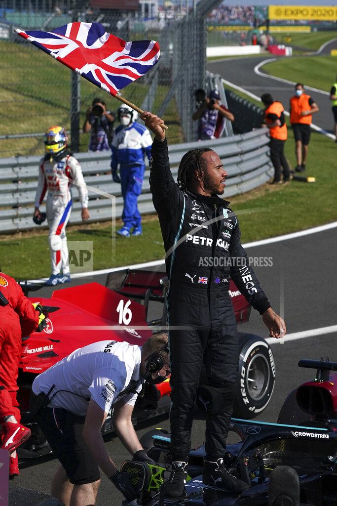 Jon Super Mercedes driver Lewis Hamilton of Britain celebrates after winning the British Formula One Grand Prix, at the Silverstone circuit, in Silverstone, England, Sunday, July 18, 2021. (AP Photo/Jon Super)