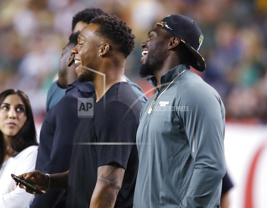 David Zalubowski Denver Broncos linebackers Brandon Marshall, left, and Shaquil Barrett look on from the sideline as Colorado State, Barrett's alma mater, hosts Colorado in the first half of an NCAA college football game Friday, Aug. 31, 2018, in Denver. (AP Photo/David Zalubowski)