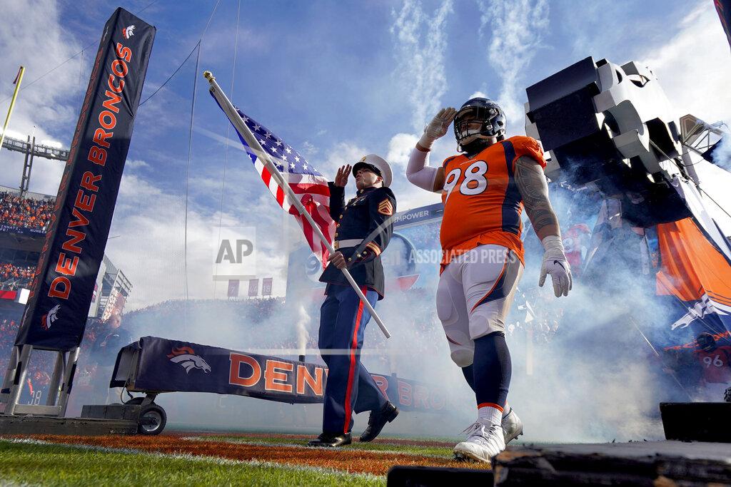 Jack Dempsey A Marine and Denver Broncos nose tackle Mike Purcell (98) salute as they take the field prior to an NFL football game against the Cleveland Browns Sunday, Nov. 3, 2019, in Denver. (AP Photo/Jack Dempsey)