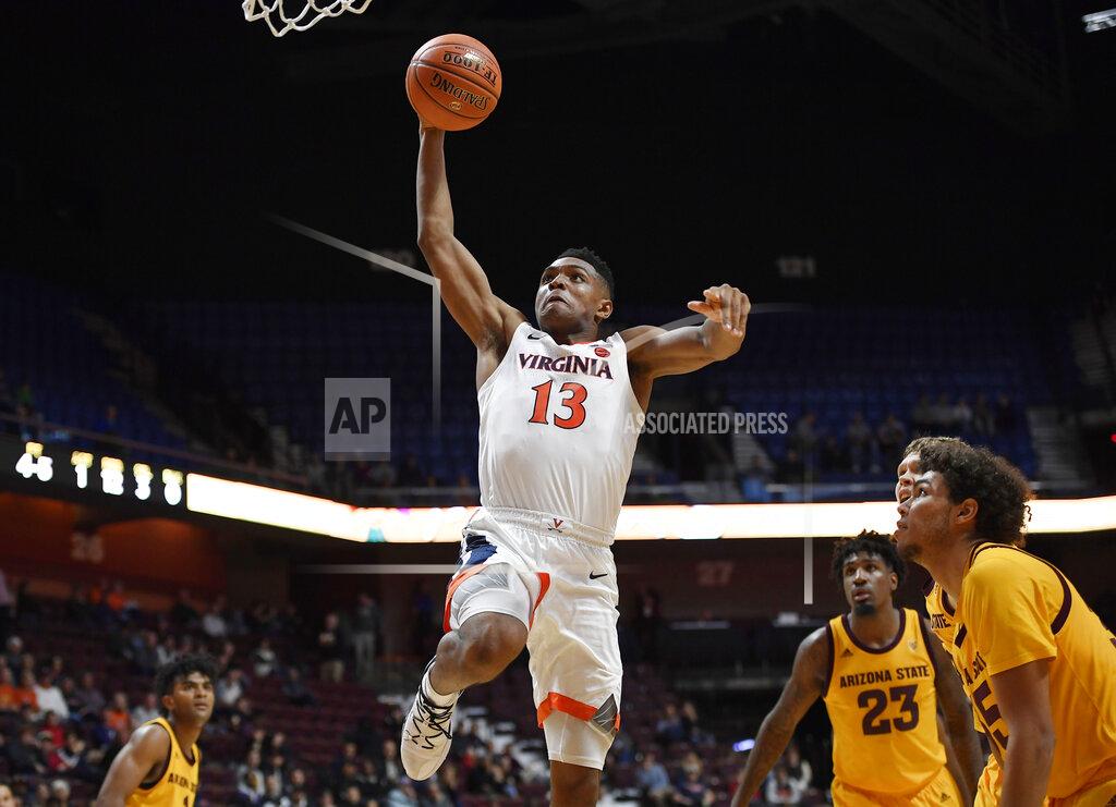 Jessica Hill Virginia's Casey Morsell goes up for a dunk as Virginia players watch during the first half of an NCAA college basketball game, Sunday, Nov. 24, 2019, in Uncasville, Conn. (AP Photo/Jessica Hill)