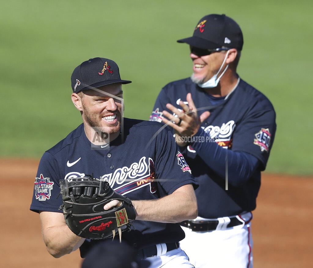 Curtis Compton / Curtis.compton@Ajc.com Atlanta Braves first baseman Freddie Freeman, foreground, shares a laugh with Chipper Jones during a baseball spring training practice before a game against the Minnesota Twins in North Port, Fla., Friday, March 5, 2021. (Curtis Compton/Atlanta Journal-Constitution via AP)