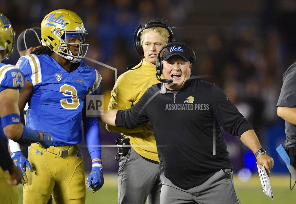 Mark J. Terrill UCLA head coach Chip Kelly, right, tries to get defensive back Rayshad Williams into the game during the second half of an NCAA college football game against Arizona Saturday, Oct. 20, 2018, in Pasadena, Calif. UCLA won 31-30. (AP Photo/Mark J. Terrill)