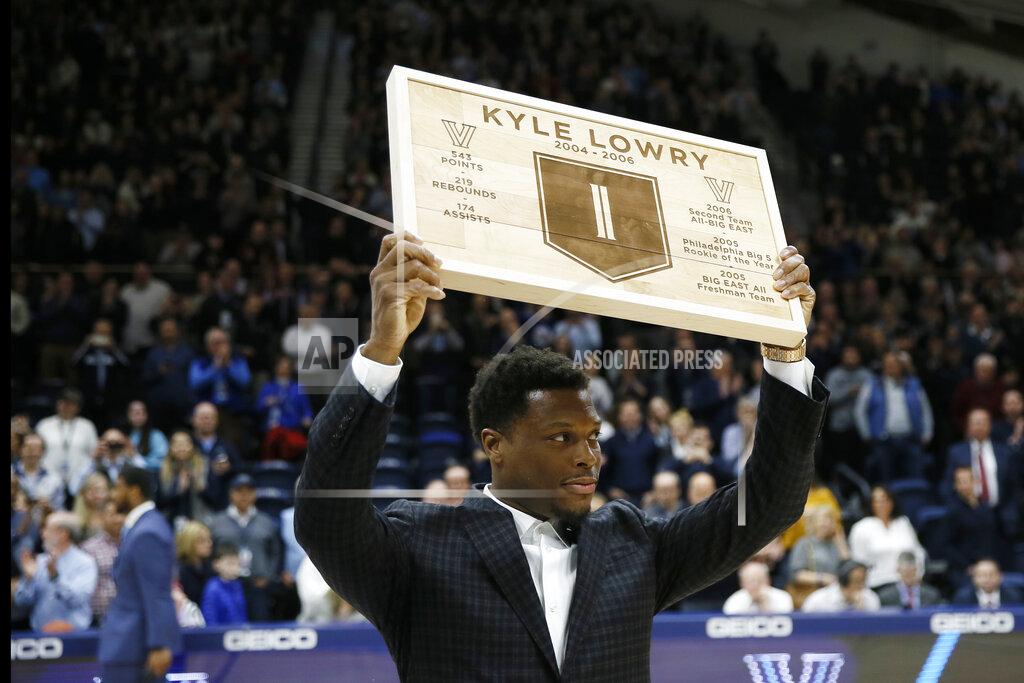 Matt Slocum Kyle Lowry, a former Villanova player and current Toronto Raptors player, holds up a plaque during a ceremony honoring him during halftime of an NCAA college basketball game between Villanova and St. John's, Wednesday, Feb. 26, 2020, in Villanova, Pa. (AP Photo/Matt Slocum)