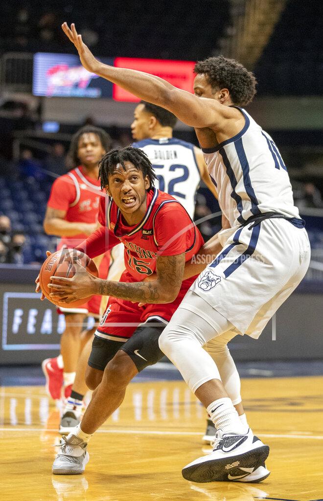 Robert Scheer St. John's guard Vince Cole (15) drives on Butler forward Bryce Nze (10), during an NCAA college basketball game in Indianapolis, Tuesday, Feb. 9, 2021. (Robert Scheer/The Indianapolis Star via AP)