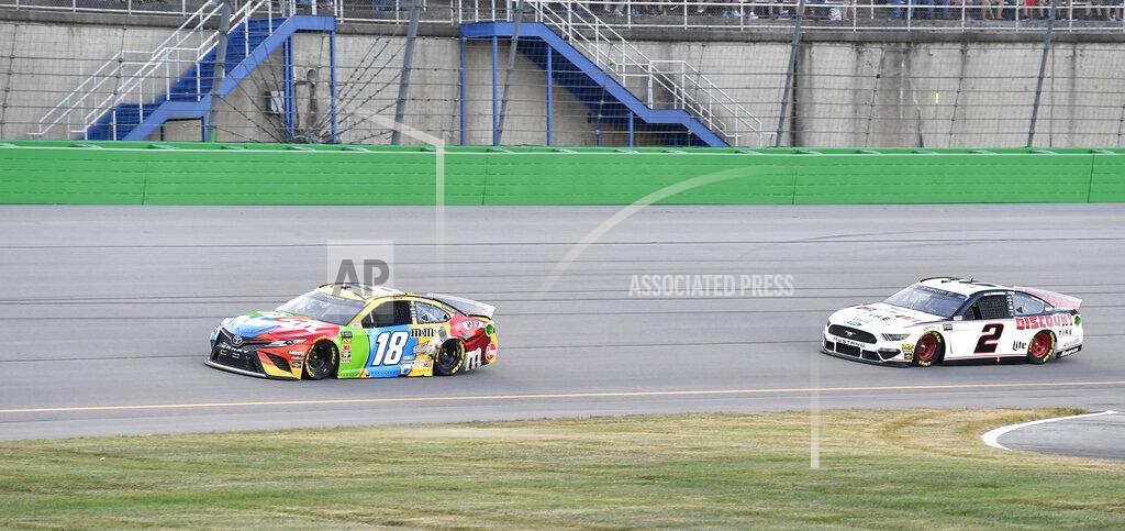 Timothy D. Easley Kyle Busch (18) drives in front of Brad Keselowski (2) into Turn 1 during the NASCAR Cup Series auto race at Kentucky Speedway in Sparta, Ky., Saturday, July 13, 2019. (AP Photo/Timothy D. Easley)