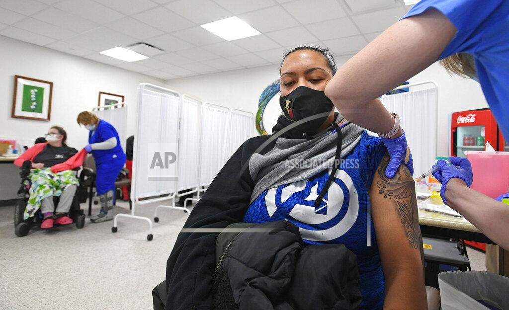 Chris Millette Janae Andrews receives a COVID-19 vaccination from Gloria Hennessy, R.N., 53, at a clinic, Jan. 29, 2021, at LECOM Center for Health & Aging, in Erie, Pa. Andrews, 30, is a supervisor at Erie-based Pitts Funeral Home, but lives in Beaver County and works at Pitts' Erie and Aliquippa locations. Andrews said she is relieved to receive her shot. "I've had (COVID-19)," she said. "This thing is no joke." LECOM officials announced Friday that they are opening vaccinations to others in Phase 1A who are not health care and front-line workers, like Andrews. (Christopher Millette/Erie Times-News via AP)