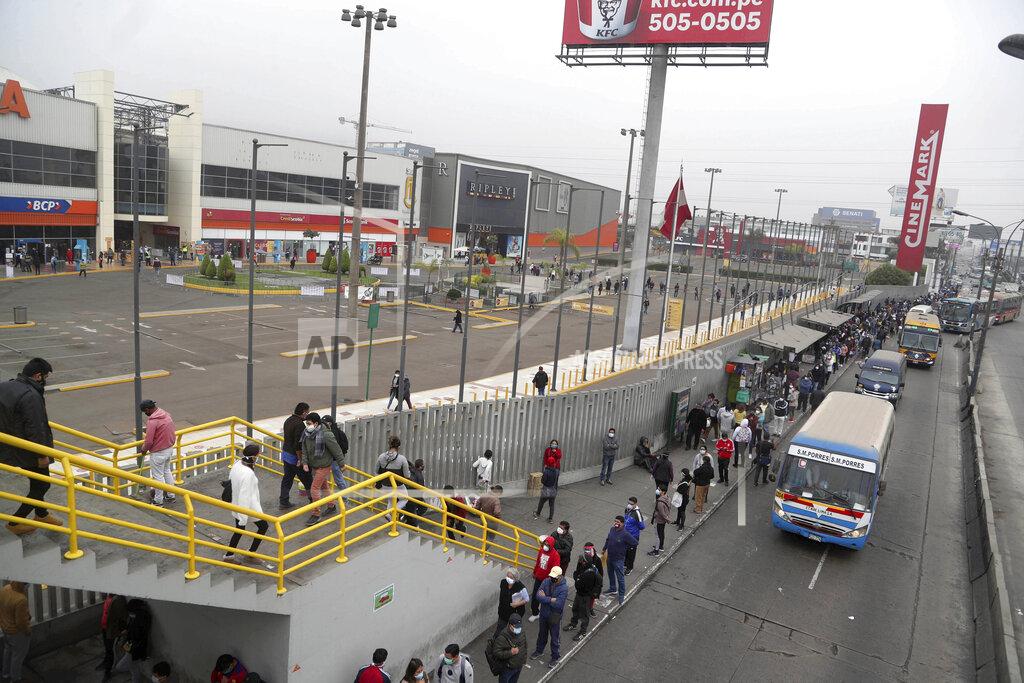 Hundreds of people wait in line outside of at Mega Plaza mall in Lima, Peru, Wednesday, June 24, 2020. Thousands of people crowded in hours-long lines after Peru’s government ignored scientific warnings and opened the country’s 90 shopping malls this week in the middle of one of the world’s worst outbreaks of coronavirus. (AP Photo/Martin Mejia)