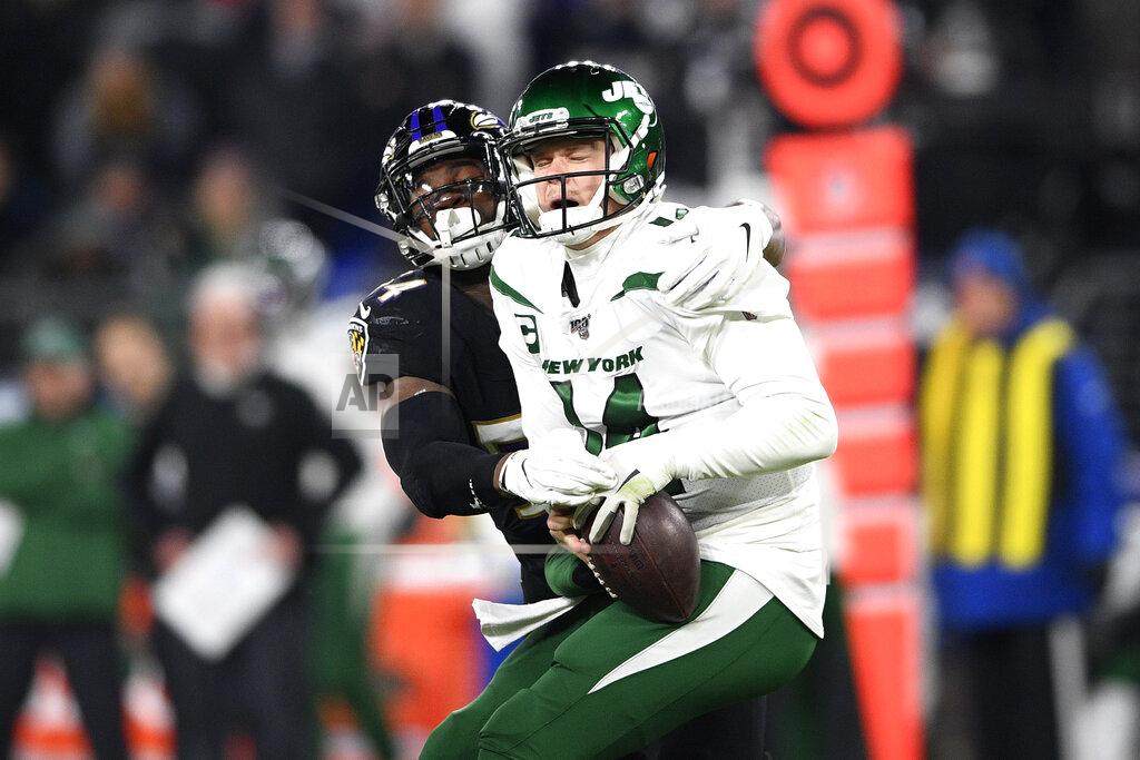 Nick Wass Baltimore Ravens linebacker Tyus Bowser, left, forces a fumble off New York Jets quarterback Sam Darnold during the second half of an NFL football game, Thursday, Dec. 12, 2019, in Baltimore. (AP Photo/Nick Wass)