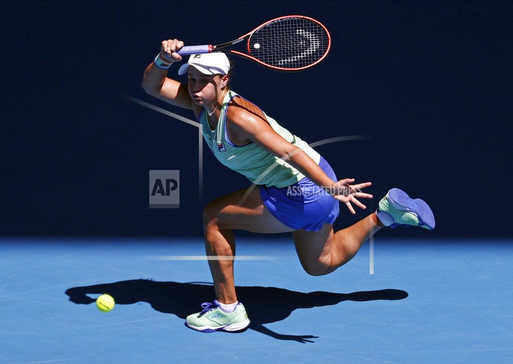 FILE - In this Jan. 30, 2020, file photo, Australia's Ashleigh Barty makes a forehand return to Sofia Kenin of the U.S. during their semifinal match at the Australian Open tennis championship in Melbourne, Australia. The heads of the ATP and WTA professional tennis tours tell the AP that they are coordinating with each other as they weigh how to reschedule the sport’s calendar for whenever play can resume after the COVID-19 pandemic. (AP Photo/Andy Wong, File)
