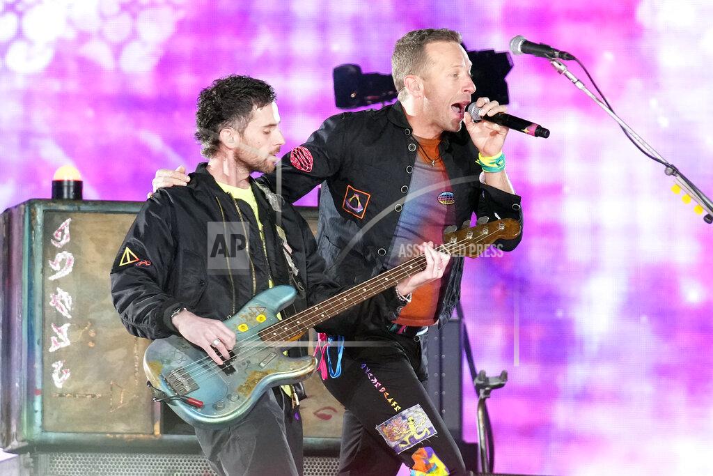 Rick Scuteri Guy Berryman, left, and Chris Martin of Coldplay performs during the band's Music of the Spheres world tour on Thursday, May 12, 2022, at State Farm Stadium in Glendale, Ariz. (Photo by Rick Scuteri/Invision/AP)
