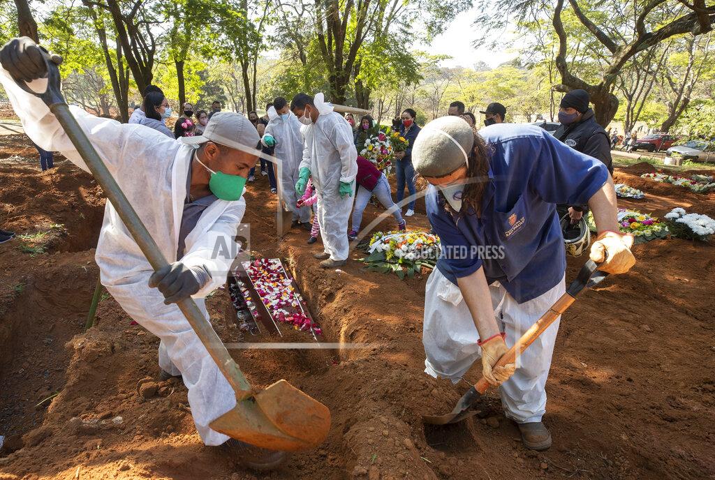 Andre Penner Cemetery workers bury 65-year-old Maria Joana Nascimento, whose family members, behind, suspect died of COVID-19, at Vila Formosa cemetery in Sao Paulo, Brazil, Thursday, Aug. 6, 2020. Brazil is nearing 3 million cases of COVID-19 and 100,000 deaths. (AP Photo/Andre Penner)