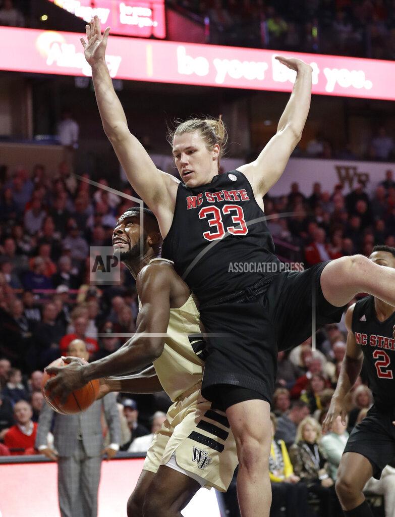Chuck Burton North Carolina State's Wyatt Walker (33) collides with Wake Forest's Ikenna Smart during the first half of an NCAA college basketball game in Winston-Salem, N.C., Tuesday, Jan. 15, 2019. (AP Photo/Chuck Burton)
