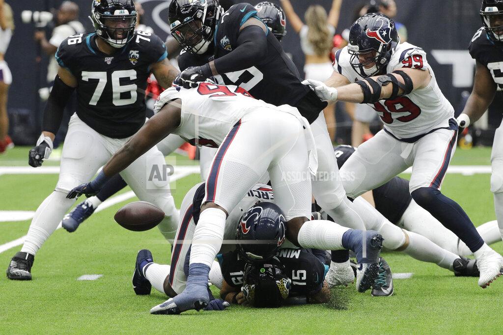 David J. Phillip Jacksonville Jaguars quarterback Gardner Minshew (15) fumbles as he is hit by Houston Texans outside linebacker Whitney Mercilus (59) during the second half of an NFL football game Sunday, Sept. 15, 2019, in Houston. (AP Photo/David J. Phillip)