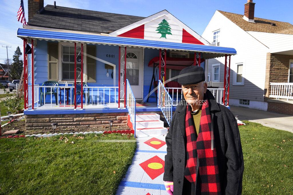 Carlos Osorio Samih Zreik stands in front of his house, Thursday, Nov. 19, 2020, in Dearborn, Mich. Zreik painted his house in tribute to Lebanon following the blast at Beirut's port that killed nearly 200 people, wounded more than 6,000 and caused billions of dollars in damage. (AP Photo/Carlos Osorio)