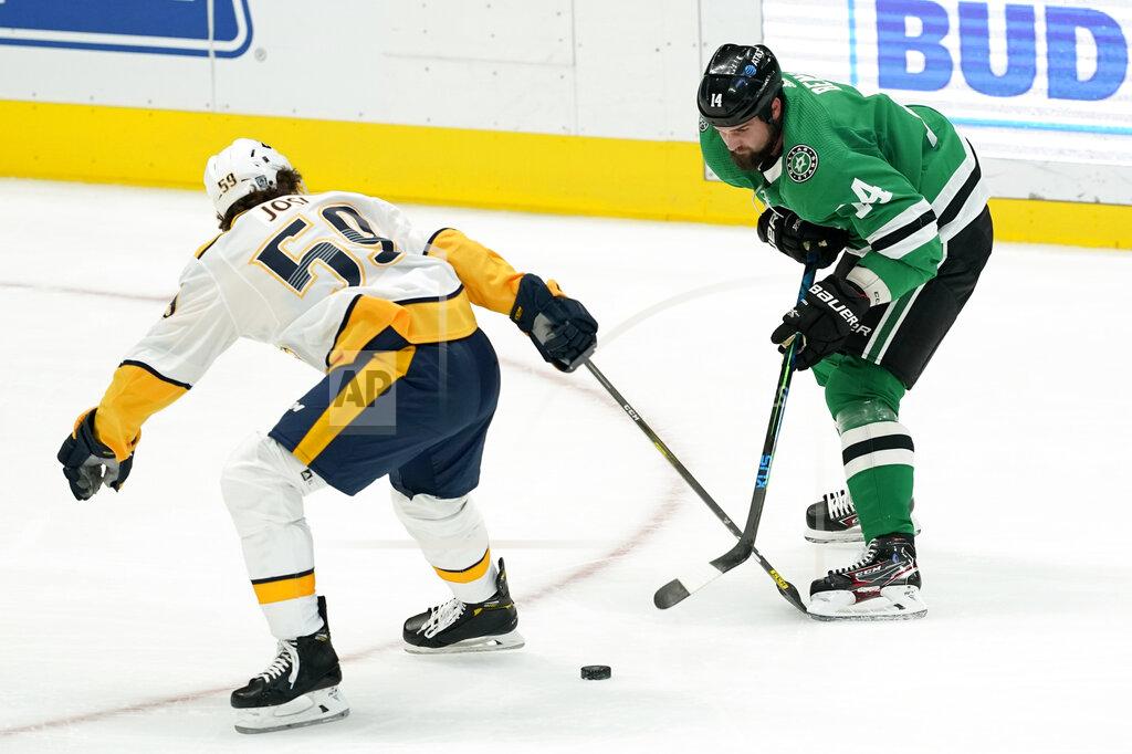Tony Gutierrez Nashville Predators defenseman Roman Josi (59) and Dallas Stars left wing Jamie Benn (14) compete for control of the puck in the first period of an NHL hockey game in Dallas, Friday, Jan. 22, 2021. (AP Photo/Tony Gutierrez)