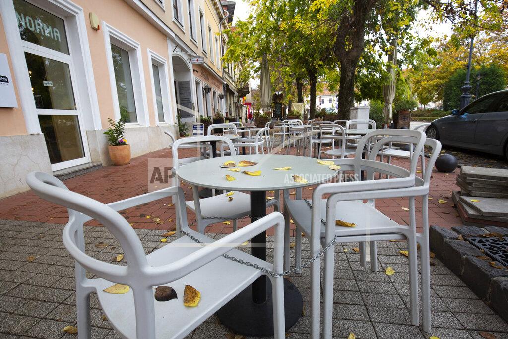 Gyorgy Varga FILE - In this Nov. 11, 2020, file photo, empty seats are seen at a restaurant's terrace in Nagykanizsa, Hungary. The European Union still hasn't completely sorted out its messy post-divorce relationship with Britain — but it has already been plunged into another major crisis. This time the 27-member union is being tested as Poland and Hungary block passage of its budget for the next seven years and an ambitious package aimed at rescuing economies ravaged by the coronavirus pandemic. (Gyorgy Varga/MTI via AP, File)