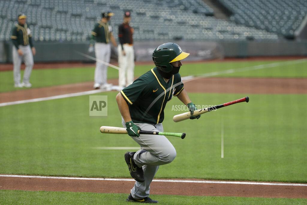 Jeff Chiu Oakland Athletics ball kid Stewart Thalblum runs with bats during the second inning of an exhibition baseball game between the Athletics and the San Francisco Giants in San Francisco, Tuesday, July 21, 2020. (AP Photo/Jeff Chiu)