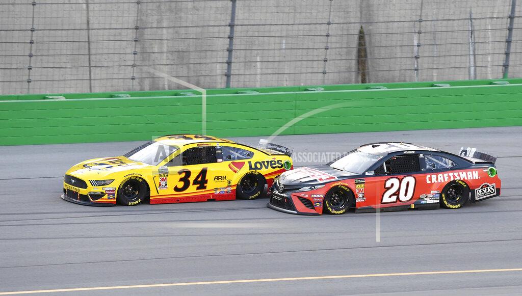 Timothy D. Easley Erik Jones (20) drives next to Michael McDowell (34) during the NASCAR Cup Series auto race at Kentucky Speedway in Sparta, Ky., Saturday, July 13, 2019. (AP Photo/Timothy D. Easley)