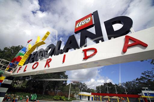 FILE - In this Tuesday, Sept. 27, 2011, file photo, a worker puts finishing touches on the entrance sign at Legoland Florida in Winter Haven, Fla. The Legoland theme park in Florida is planning an expansion next year including new rides, according to plans filed with the city nearest the attraction. The details have not been revealed, but news outlets report Legoland will add about 4.5 acres (1.8 hectares) to its resort near Winter Haven.(AP Photo/John Raoux, File)