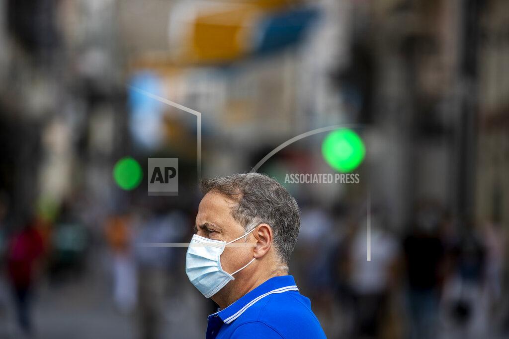Manu Fernandez A man wearing a face mask to prevent the spread of coronavirus stands in downtown Madrid, Spain, Wednesday, Sept. 16, 2020. The Spanish capital will introduce selective lockdowns in urban areas where the coronavirus is spreading faster, regional health authorities announced on Tuesday. (AP Photo/Manu Fernandez)