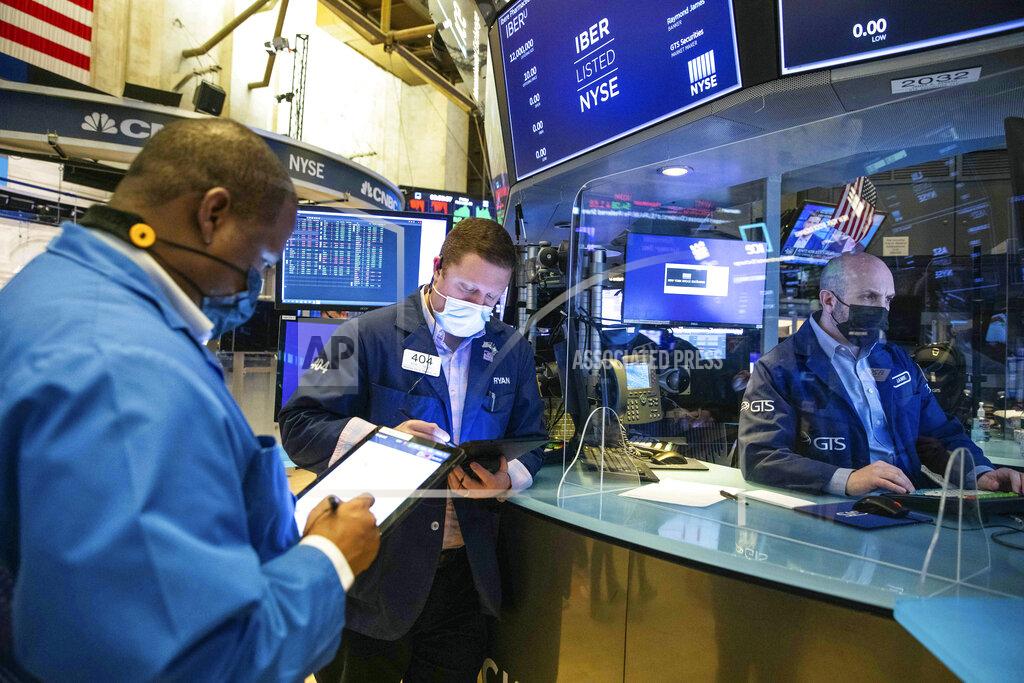 Courtney Crow In this photo provided by the New York Stock Exchange, traders work on the floor, Friday, Feb 26, 2021. Stocks wobbled between small gains and losses on Wall Street Friday as rising technology stocks offset a slide in banks and energy companies. (Courtney Crow/New York Stock Exchange via AP)