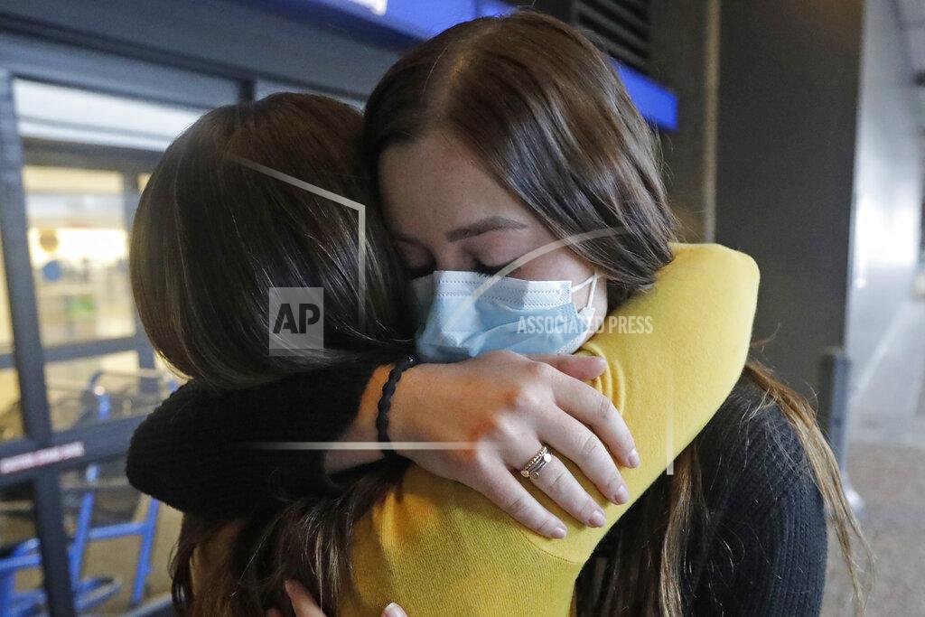 Rick Bowmer In this May 27, 2020, photo, Shaelee Palmer, 20, right, a missionary from The Church of Jesus Christ of Latter-day Saints, says goodbye to her mother Amber at Salt Lake City International Airport before leaving on her mission to North Carolina. After hastily bringing home 26,000 young men and women who were serving in foreign countries, the faith has begun sending many of them out again in their home countries with a new focus on online work that could stick even when the pandemic is over, church officials told The Associated Press. (AP Photo/Rick Bowmer)