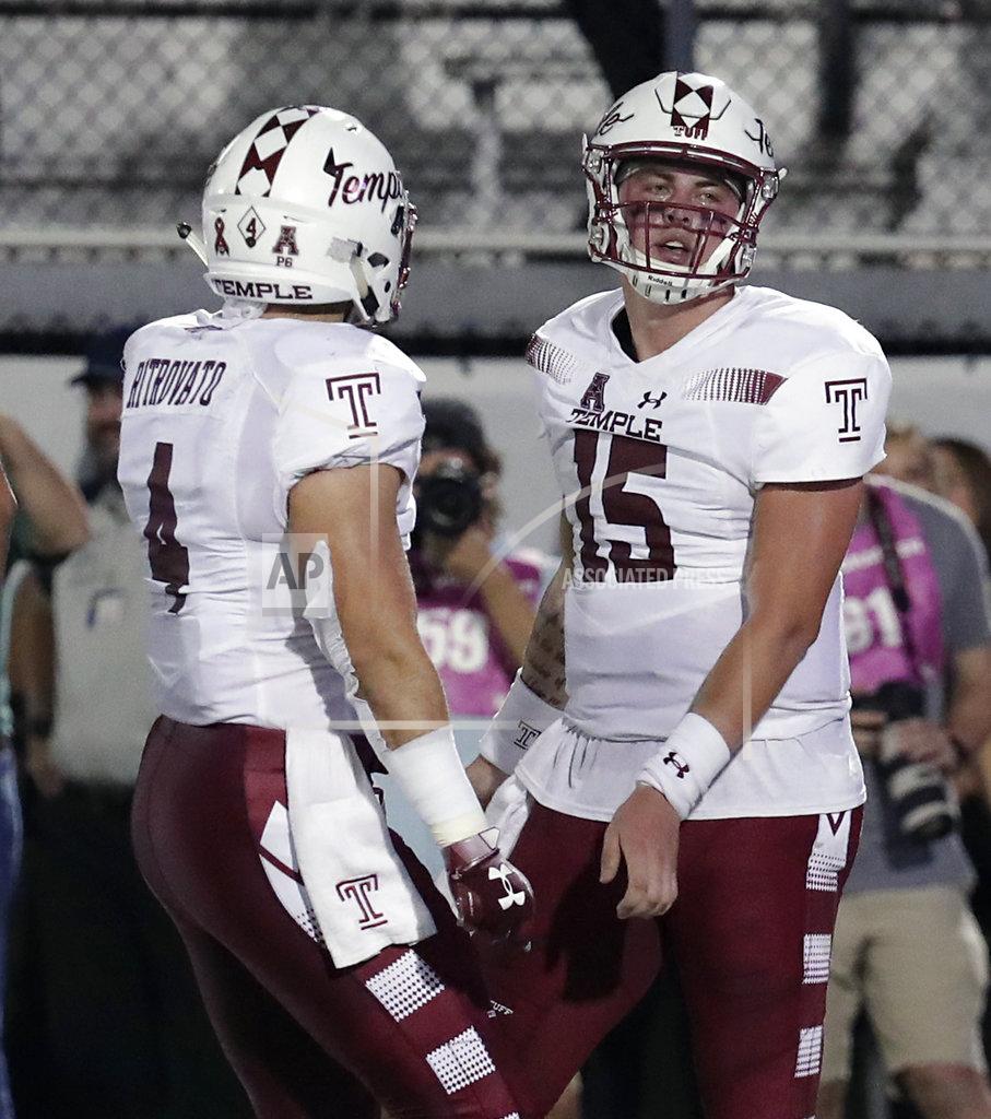 John Raoux Temple quarterback Anthony Russo (15) celebrates his 5-yard touchdown run on a fake punt with fullback Rob Ritrovato (4) during the first half of an NCAA college football game against Central Florida, Thursday, Nov. 1, 2018, in Orlando, Fla. (AP Photo/John Raoux)