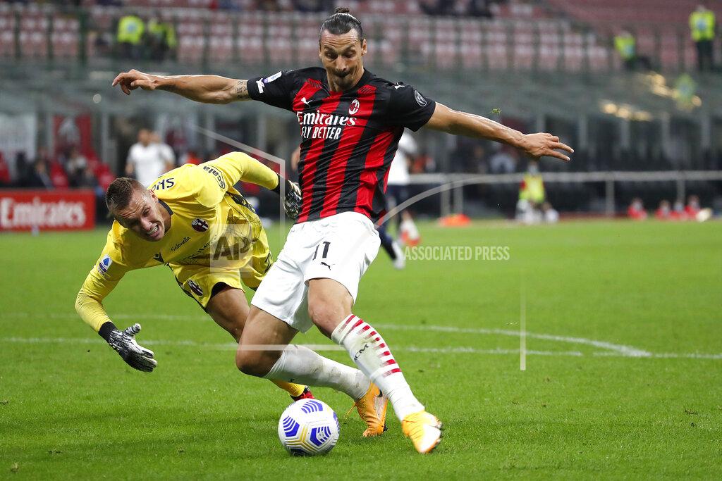 Antonio Calanni AC Milan's Zlatan Ibrahimovic, right, controls the ball by Bologna's goalkeeper Lukasz Skorupski during the Serie A soccer match between AC Milan and Bologna at the San Siro stadium, in Milan, Italy, Monday, Sept. 21, 2020. (AP Photo/Antonio Calanni)