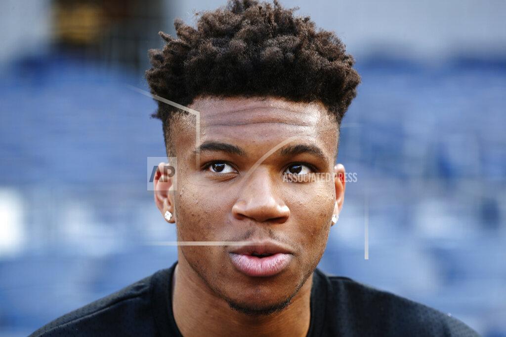 Kathy Willens FILE - In this July 15, 2019, file photo, Milwaukee Bucks' Giannis Antetokounmpo speaks to reporters at batting practice before a baseball game between the New York Yankees and the Tampa Bay Rays, in New York. This season’s NBA MVP has won the award before. A trio of past winners of the award — reigning MVP Giannis Antetokounmpo of the Milwaukee Bucks, four-time MVP LeBron James of the Los Angeles Lakers and 2017-18 winner James Harden of the Houston Rockets — were announced Saturday, Aug. 8, 2020, as the finalists for this season’s top NBA individual honor. (AP Photo/Kathy Willens, File)