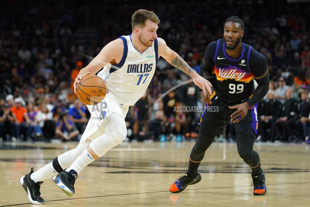 Matt York Dallas Mavericks guard Luka Doncic (77) drives as Phoenix Suns forward Jae Crowder (99) defends during the second half of Game 7 of an NBA basketball Western Conference playoff semifinal, Sunday, May 15, 2022, in Phoenix. The Mavericks defeated the Suns 123-90. (AP Photo/Matt York)