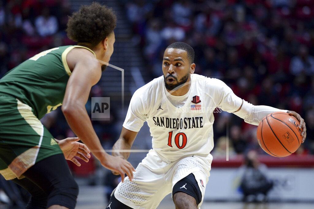 Orlando Ramirez San Diego State guard KJ Feagin (10) dribbles the ball while defended by Cal Poly guard Junior Ballard during the first half of an NCAA college basketball game Saturday, Dec. 28, 2019, in San Diego. (AP Photo/Orlando Ramirez)
