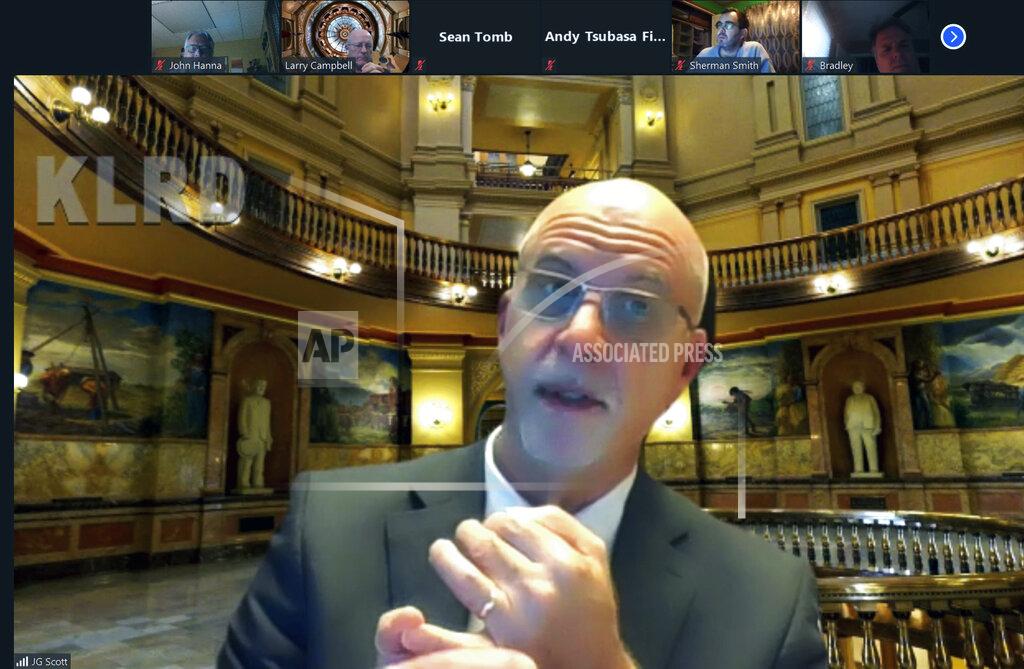 John Hanna FILE - This Nov. 6, 2020, file image from a video Zoom meeting shows J.G. Scott, the director of the Kansas Legislative Research Department, discussing a new fiscal forecast for state government in Topeka, Kan. A year after COVID-19 triggered government shutdowns and crowd limitations, more public bodies than ever are livestreaming their meetings for anyone to watch from a computer, television or smartphone. But in some cases, it's become harder for people to actually talk with their elected officials. (AP Photo/John Hanna, File)