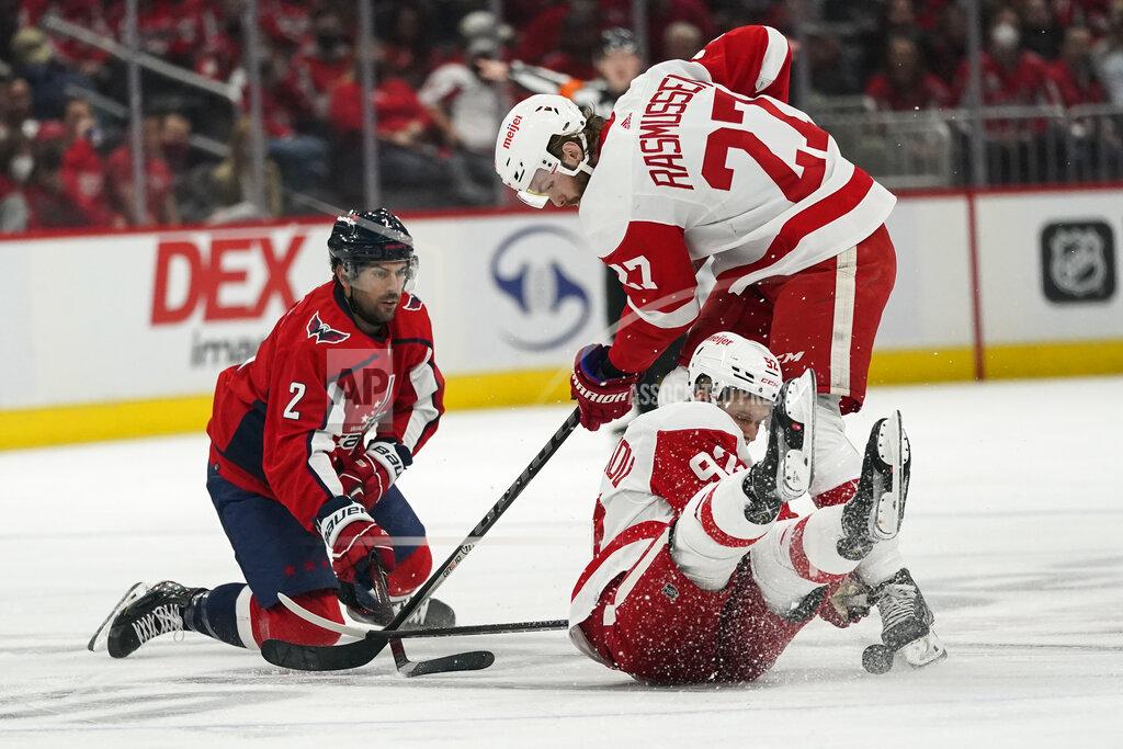 Alex Brandon Washington Capitals defenseman Justin Schultz (2), Detroit Red Wings center Michael Rasmussen (27) and Detroit Red Wings center Vladislav Namestnikov (92) loose track of the puck as they collide in the first period of an NHL hockey game, Wednesday, Oct. 27, 2021, in Washington. (AP Photo/Alex Brandon)