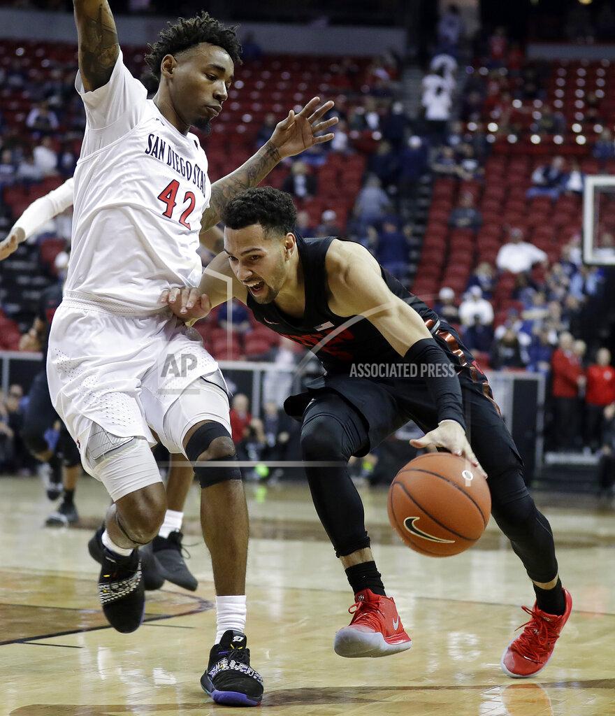 Isaac Brekken San Diego State's Jeremy Hemsley (42) defends as UNLV's Noah Robotham drives during the second half of an NCAA college basketball game in the Mountain West Conference men's tournament Thursday, March 14, 2019, in Las Vegas. (AP Photo/Isaac Brekken)