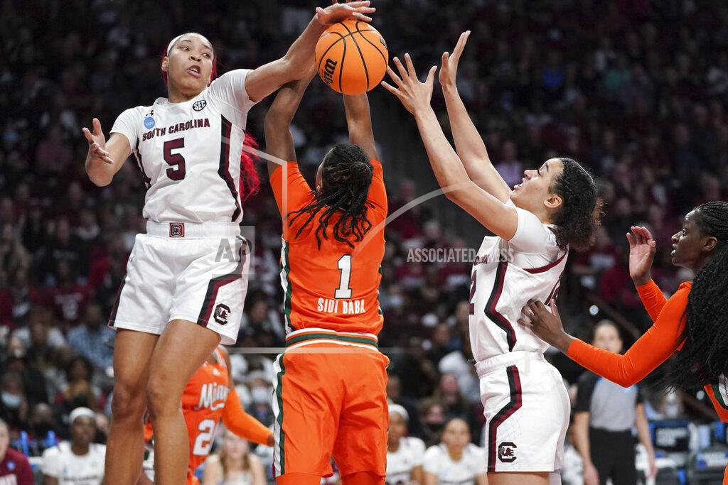 Sean Rayford South Carolina forward Victaria Saxton (5) and guard Brea Beal (12) battle for a loose ball against Miami guard Moulayna Johnson Sidi Baba (1) during the second half of a second-round game in the NCAA college basketball tournament, Sunday, March 20, 2022, in Columbia, S.C. South Carolina won 49-33. (AP Photo/Sean Rayford)