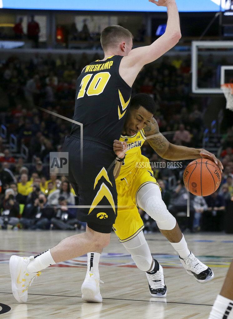 Kiichiro Sato Michigan's Charles Matthews drives against Iowa's Joe Wieskamp (10) during the first half of an NCAA college basketball game in the quarterfinals of the Big Ten Conference tournament, Friday, March 15, 2019, in Chicago. (AP Photo/Kiichiro Sato)