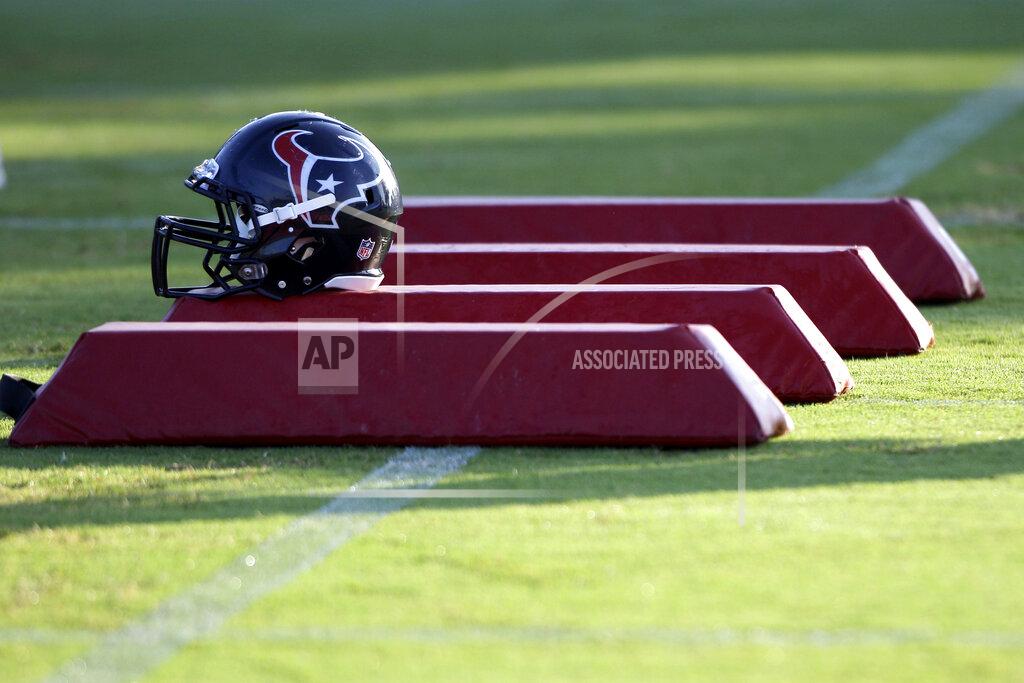 David J. Phillip FILE - In this Aug. 3, 2010, file photo, a Houston Texans helmet sits on pads during NFL football training camp in Houston. As teams adhere to the medical protocols that wisely and necessarily have been ordered by the league and the players’ union, any sort of football action might be delayed until mid-August. (AP Photo/David J. Phillip, File)
