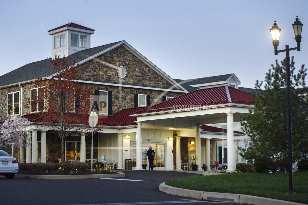 Stephanie Strasburg A person enters The Birches at Newtown assisted living facility, Tuesday, April 13, 2021, in Newtown, Pa. The deaths at the home and many others across Pennsylvania highlight the dangers that residents with dementia faced during the coronavirus pandemic and a state oversight system that imposed few protections during the worst of the crisis. (Stephanie Strasburg/Pittsburgh Post-Gazette via AP)
