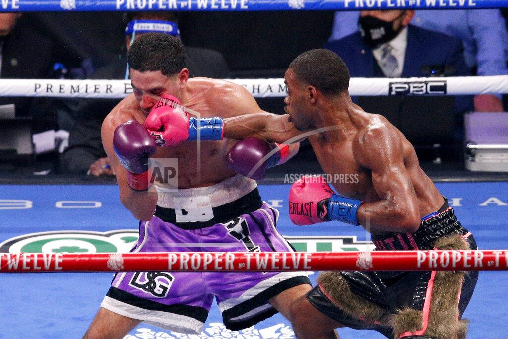 Brandon Wade Danny Garcia, left, is hit by Errol Spence Jr. during the WBC IBF welterweight championship boxing bout in Arlington, Texas, Saturday, Dec. 5, 2020. (AP Photo/Brandon Wade)